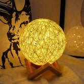 Huitich rattan light glowing softly on wooden stand decorative LED bedside lamp